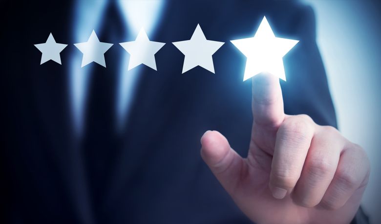 Hand of a businessman touches five star symbol